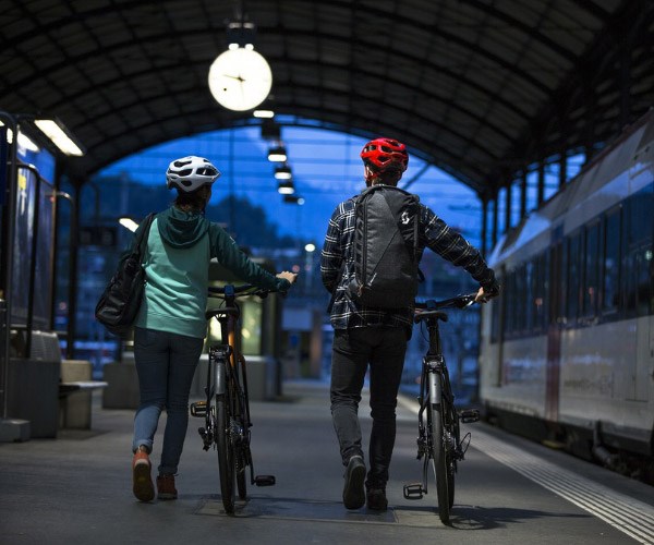 Two cycle commuters leaving a train station